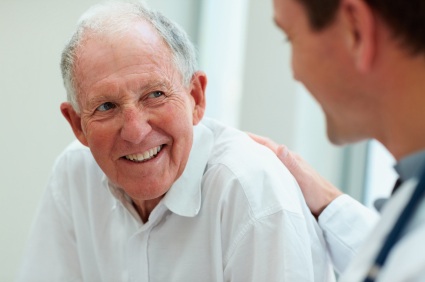 Older man talking to Edmond restorative dentist Dr. James Peck.